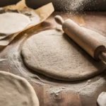 Cottage cheese flatbread being rolled out on a floured surface.