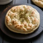 Cottage cheese flatbread on a wooden table.